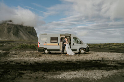 bride and groom embracing on mountain