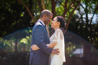 Groom nuzzling bride's temples both eyes close smiling underneath her veil by Charlotte wedding photographers DeLong Photography