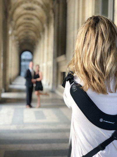 Over the shoulder view of Cari Long photographing a vow renewal photography session in Paris