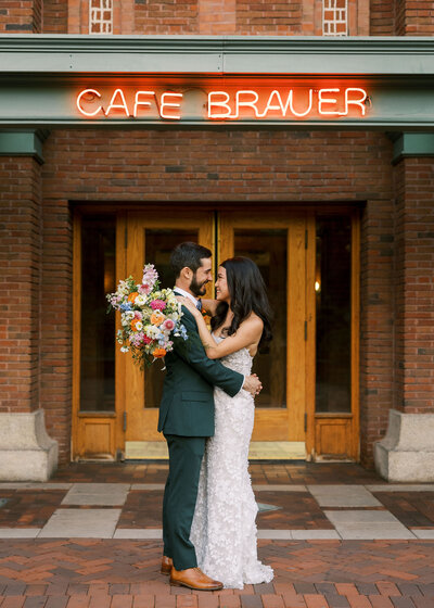 Newlyweds pose after ceremony in front of Chicago's Cafe Brauer