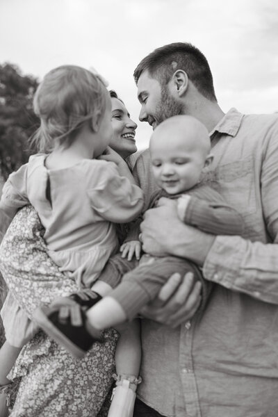 couple holds children