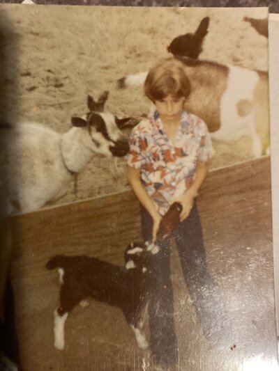 Old picture of dean as a child feeding a goat