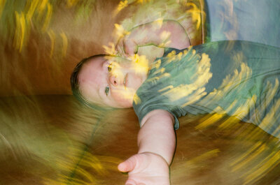 double exposure of toddlery on couch with yellow flowers
