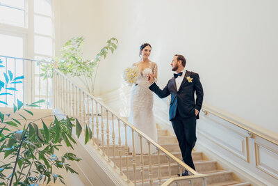 langham hotel pasadena wedding on interior stairs with window light designer dress and tux