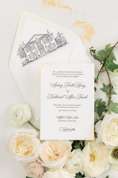Elegant wedding invitation idea of letterpress wedding invitation design featuring hand-torn paper, gold leaf accents, and a custom venue illustration as the envelope liner.