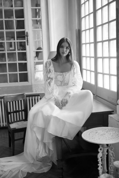 black and white image bride wearing  long sleeve lace wedding dress