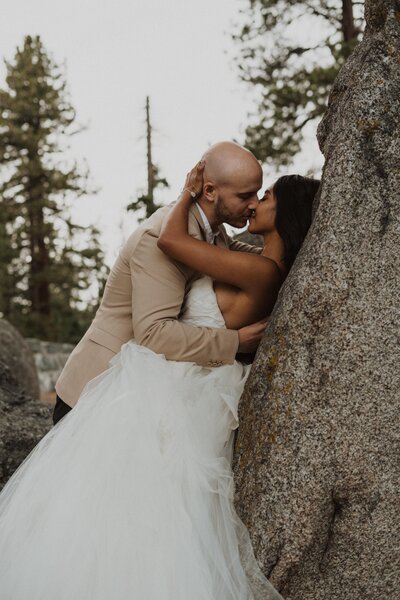 bride and groom embracing in woods