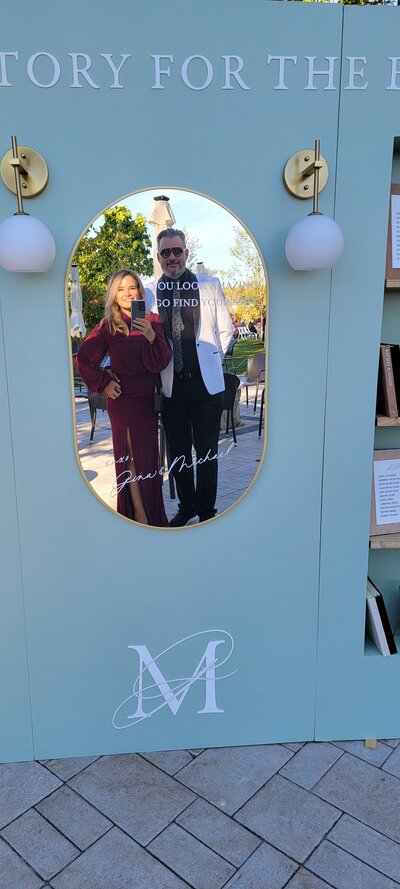 Mirror selfie of Vicki + Kevin, owners of Cove Mill Design Co. in the reflection of the mirror of one of their Welcome sign builds at a wedding in Maine.