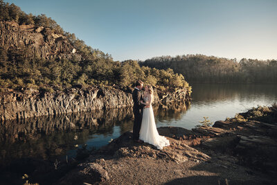 Eloping couple kisses upon the rocks