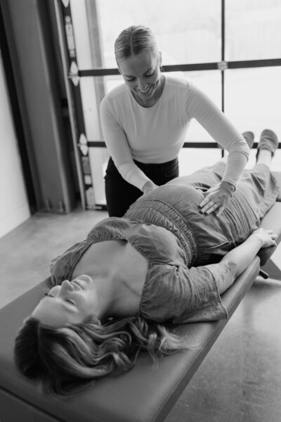 pregnant woman getting adjusted on chiropractic table
