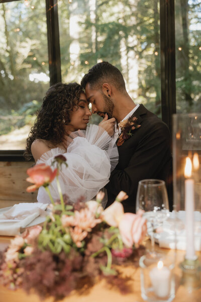 Wedding in the forest, western decor groom dipping bride and kissing her