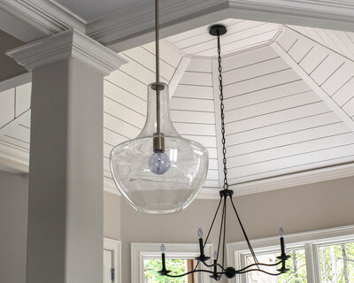 Beautiful Staircase that has white shiplap and sconces and is the style of modern farmhouse.