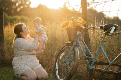Mother lovingly looks at her daughter during their family photoshoot. By Amanda Touchstone, an Athens Family Photographer