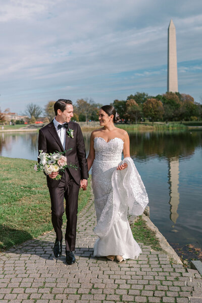 Couple walking down aisle while being celebrated by friends and family