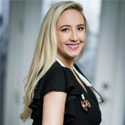 Smiling blonde woman in black professional attire, personal branding headshot in NYC and New Jersey.