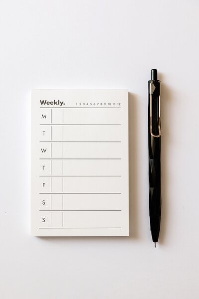 Weekly Planner and a Pen