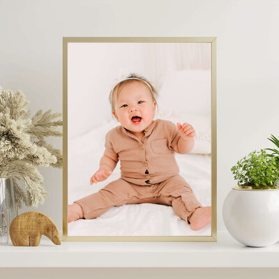 framed photo of baby laughing during BransonMO baby milestone photography session