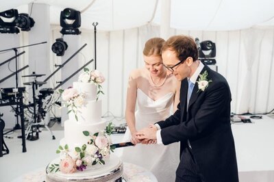 Sophie & Max cutting their wedding cake