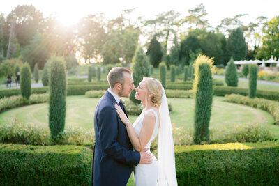 couple in the gardens by the maze at tortworth hall summer wedding