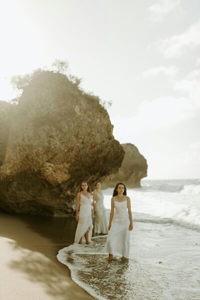 Three women standing on beach