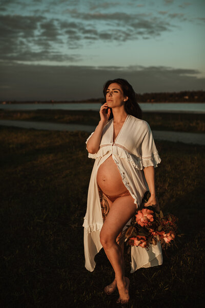 pregnant woman in lace dress with bouquet