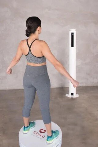 Woman using the Styku 3D body scanner at Wellness and Hormone Health in Centennial, Colorado for full-body composition analysis and weight loss tracking