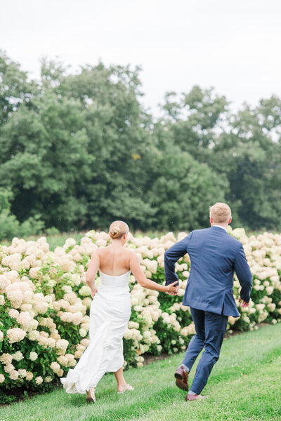 couple exits outdoor wedding ceremony smiling as newlyweds in upstate new york