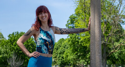 a woman stands by a lamppost to tell you about online strength training programs