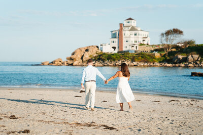 Gloucester MA engagement photos at Good Harbor Beach with shoreline views and soft natural light.
