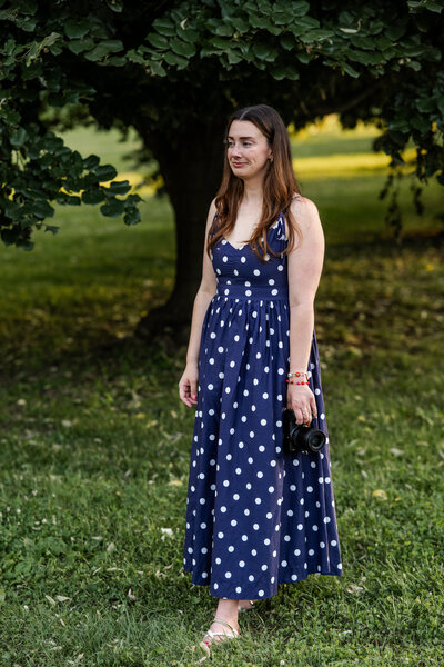 Kate Kosnoff looking into the distance during candid headshot moment while holding her camera