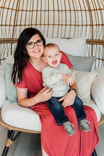 Woman in red dress holding baby