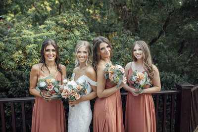 The English Manor | Bride and bridesmaids smiling during summer wedding photo | Ocean Township, New Jersey
