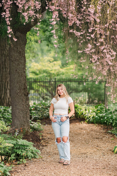 Family photographer captures mom and daughters in a blooming garden near Lancaster, PA