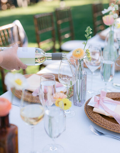 Wedding Photography, Waiter pouring wine into a glass at reception