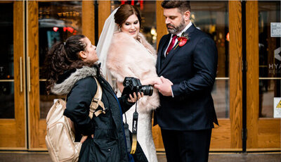 wedding photographer helping couple with posing