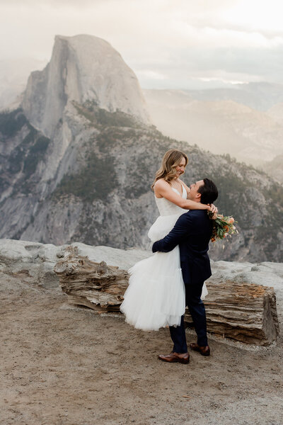 A bride and groom walk through Tuolumne Meadows in Yosemite National Park. 