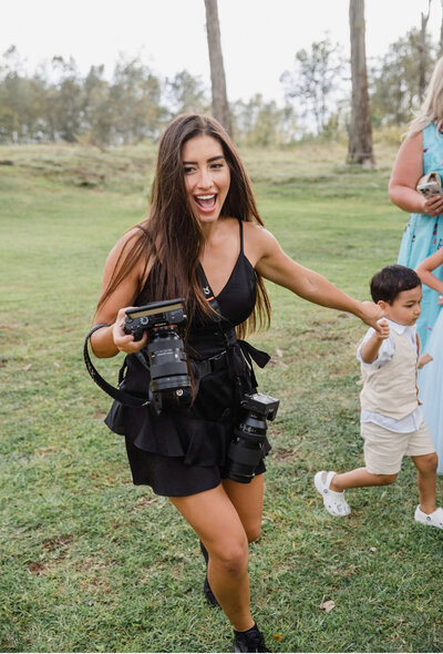 Big Island Hawaii photographer smiling and holding her camera