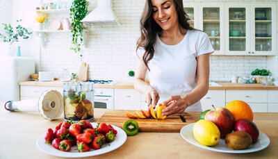 Woman chopping fruit in her kitchen