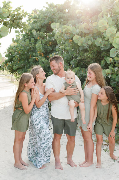 Family laughing and smiling at each other during their photo session owith an Orlando photographer