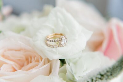 Elegant engagement ring set atop bouquet of flowers