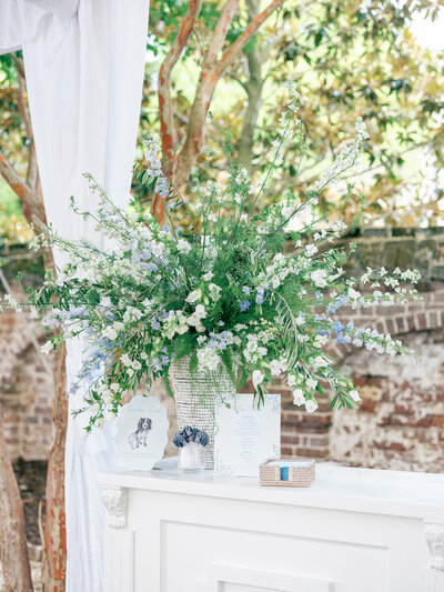Lush wedding floral arrangement on wedding reception bar