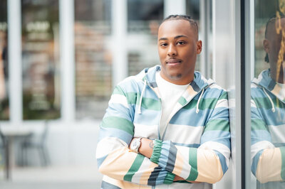 Headshot photo of Jamaad "Maadist" Gould, arms crossed