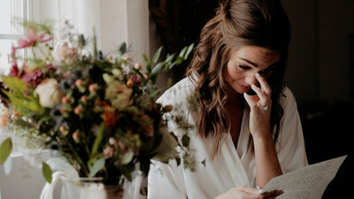 Emotional bride reading letter