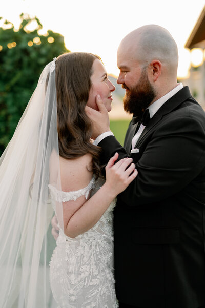 black and white image by bauer creative of bride and groom happily walking back down aisle together while guests cheer behind minneapolis wedding