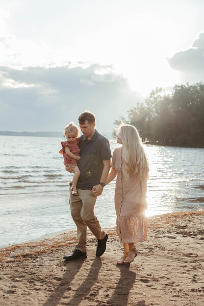 Bride and Groom walk alongside shoreline