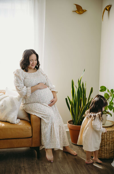 Shenandoah wedding photographed by charlottesville wedding photographer with bride adn groom in a yellow wildflower field leaning in to kiss each other as the sunsets over the mountains in the distance for a summer wedding
