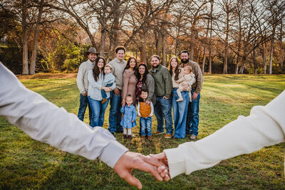 Large family session with grandparents standing in front holding hands during sunset in New Braunfels, TX."