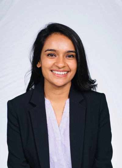 headshot of Dr. Patel in a white shirt and black blazer