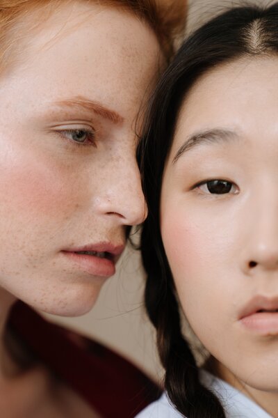 A close-up image of a redheaded girl and an Asian girl, highlighting the diversity and inclusivity at Laserderm. Our dedicated team is ready to assist you with personalised skincare solutions tailored to your individual needs. Contact us today to schedule a consultation and let us guide you towards healthy, glowing skin. We're here to help you achieve your aesthetic goals and boost your confidence.
