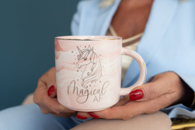 Coffee cup featuring a playful pink unicorn design, used by a divorce guidance coach. This whimsical cup represents the supportive and uplifting approach in guiding clients through their divorce journey."